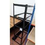 2 off black metal storage racks, each capable of holding five shelves, one assembled and one not ass