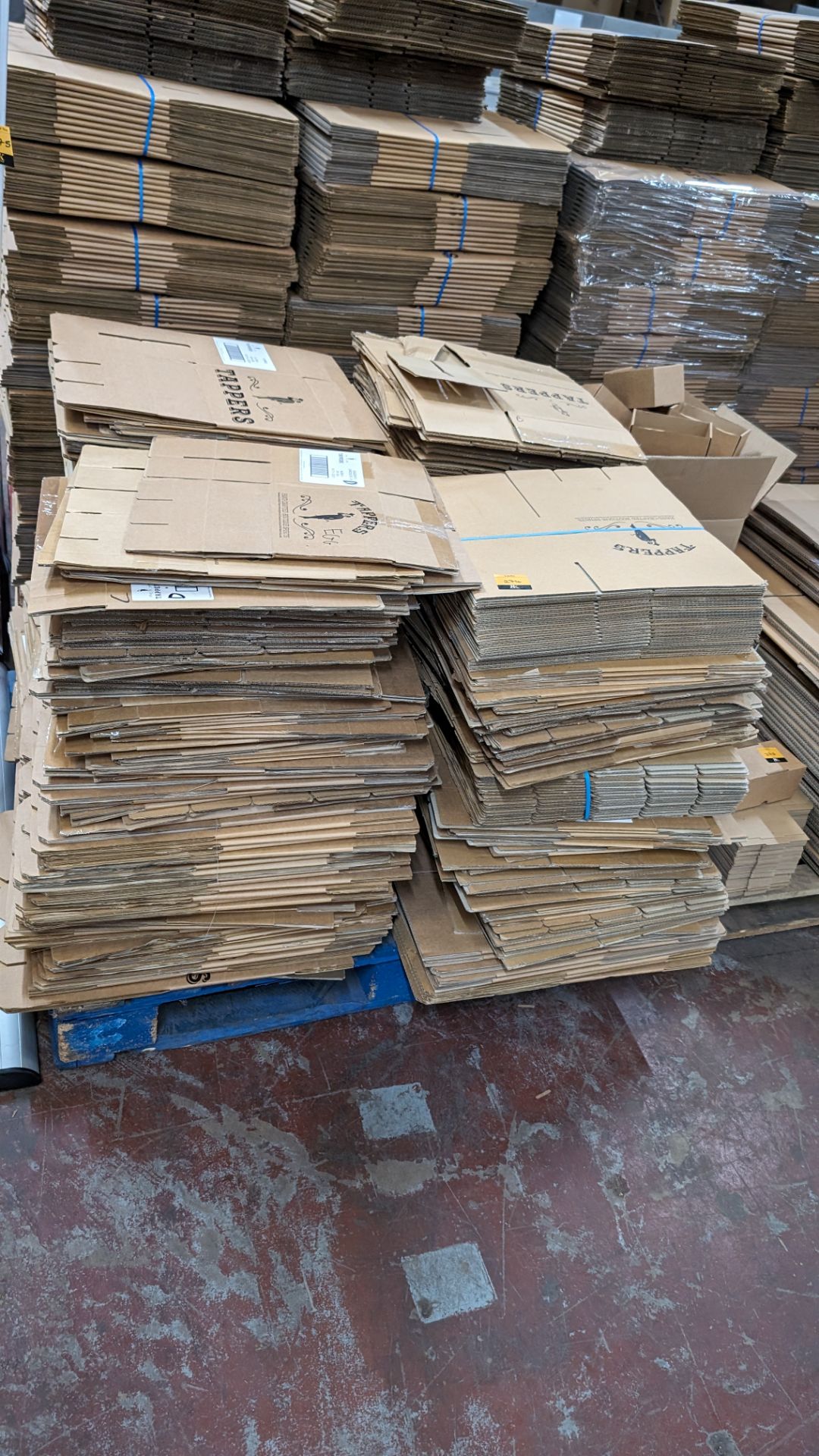 The contents of a pallet of flatpack cardboard boxes in 4 stacks. Each box when assembled incorpora