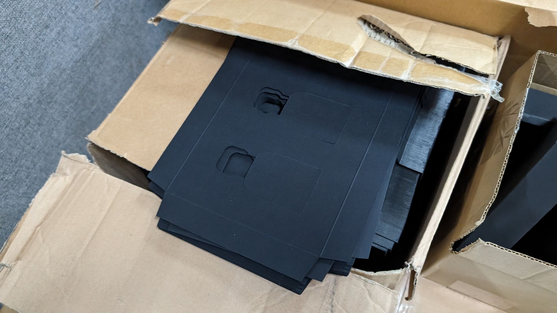 The contents of a pallet of assorted packaging materials primarily comprising flatpack black boxes b - Image 6 of 12