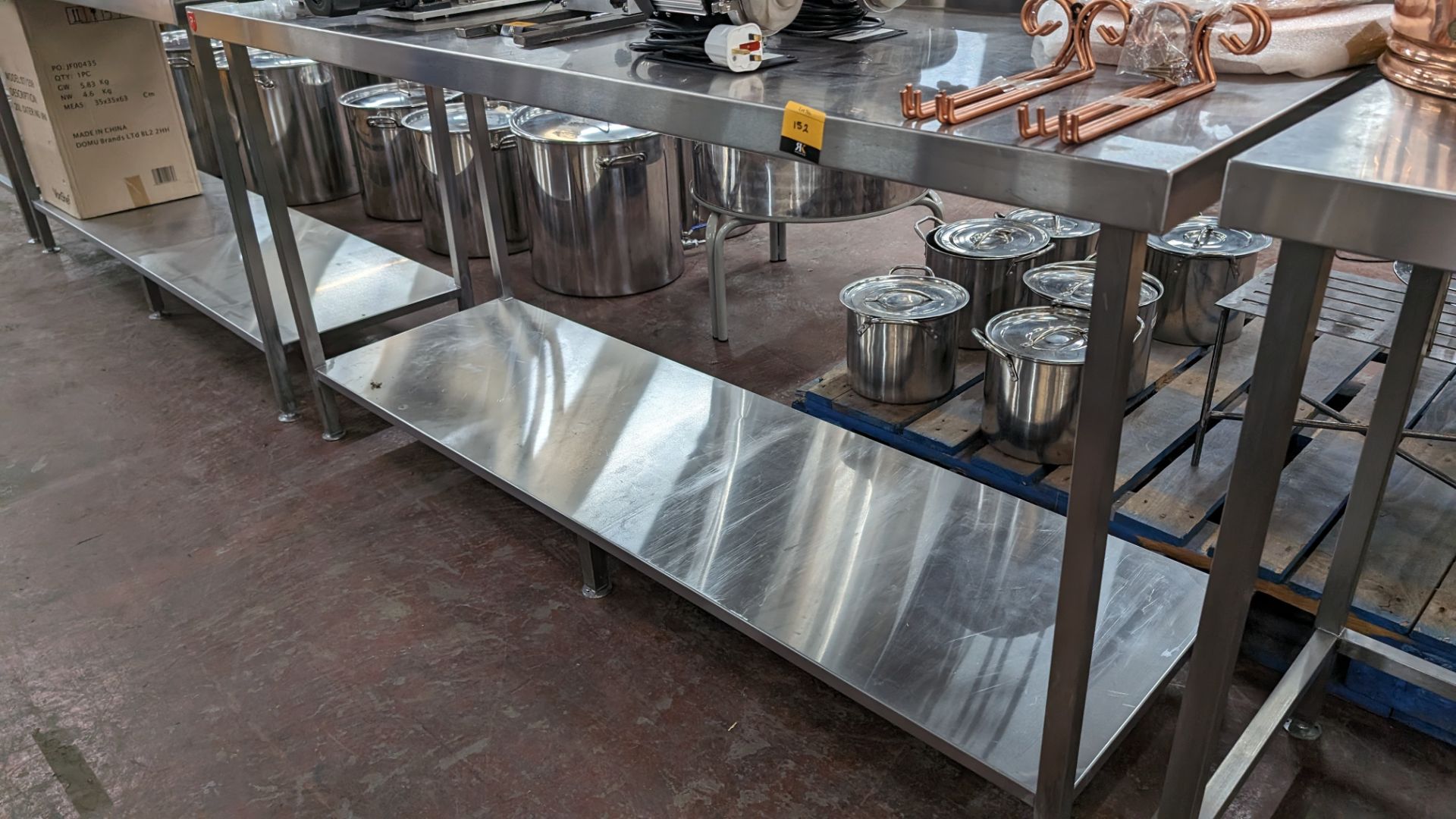 Stainless steel twin tier table with upstand at rear, max dimensions: 920mm x 600mm x 1800mm