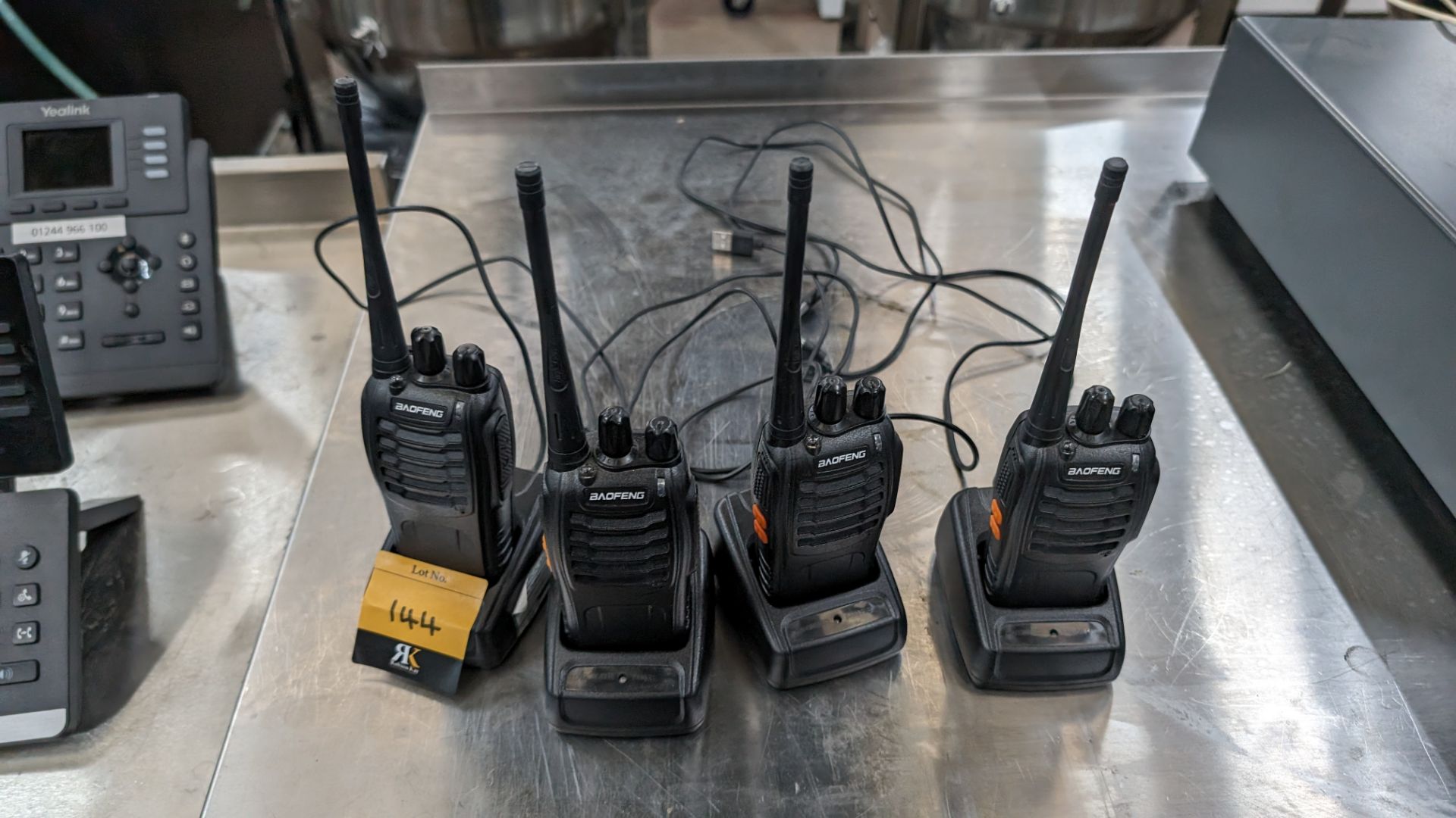 4 off Baofeng walkie-talkies each with their own charging base