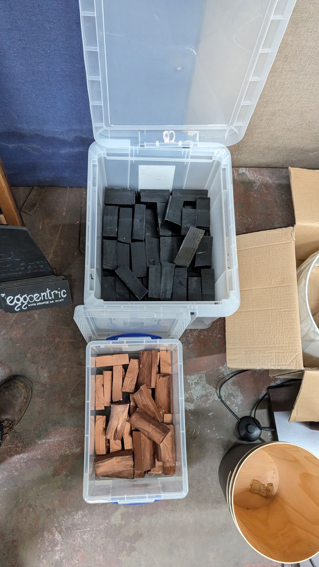 The contents of 2 crates of blocks of wax in black and gold