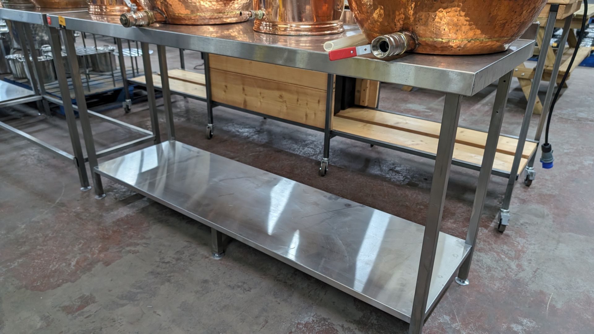 Stainless steel twin tier table with upstand at rear, max dimensions: 920mm x 600mm x 1800mm