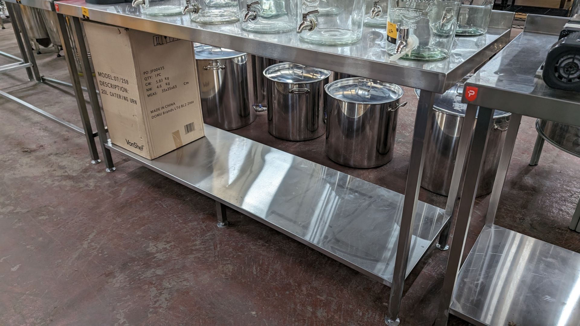 Stainless steel twin tier table with upstand at rear, max dimensions: 920mm x 600mm x 1800mm