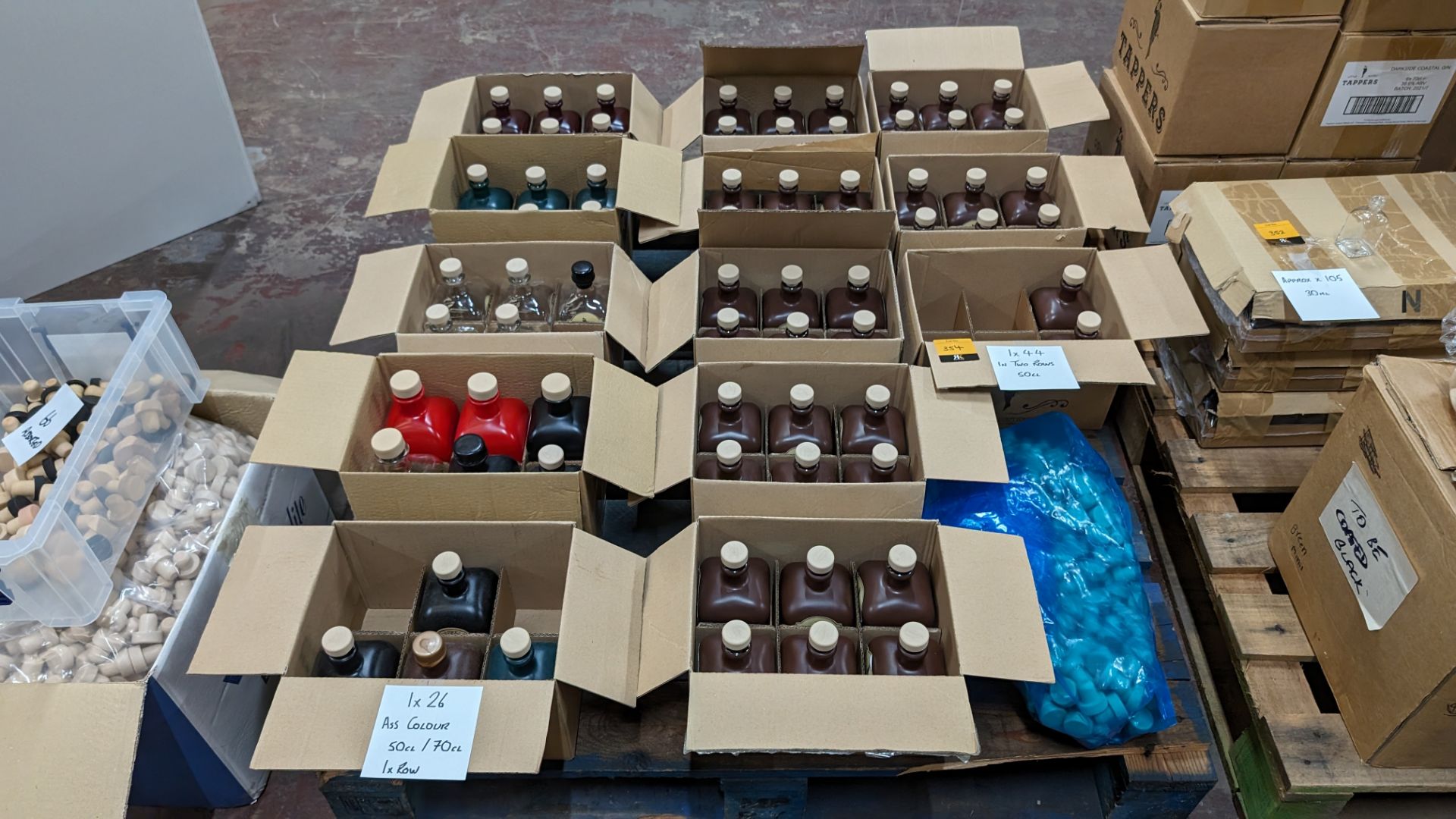 The contents of a pallet of bottles and stoppers. This lot comprises 70 off glass bottles, mostly p