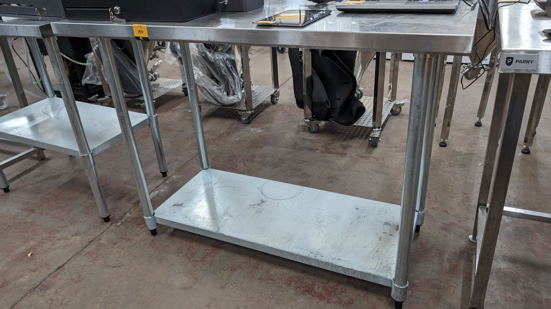 Stainless steel twin tier table with upstand at rear, max dimensions: 940mm x 610mm x 1220mm