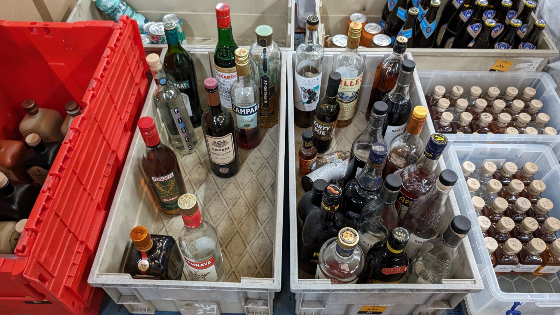 The contents of a crate of opened bottles of assorted spirits, liqueurs and bitters. Sold under AWR