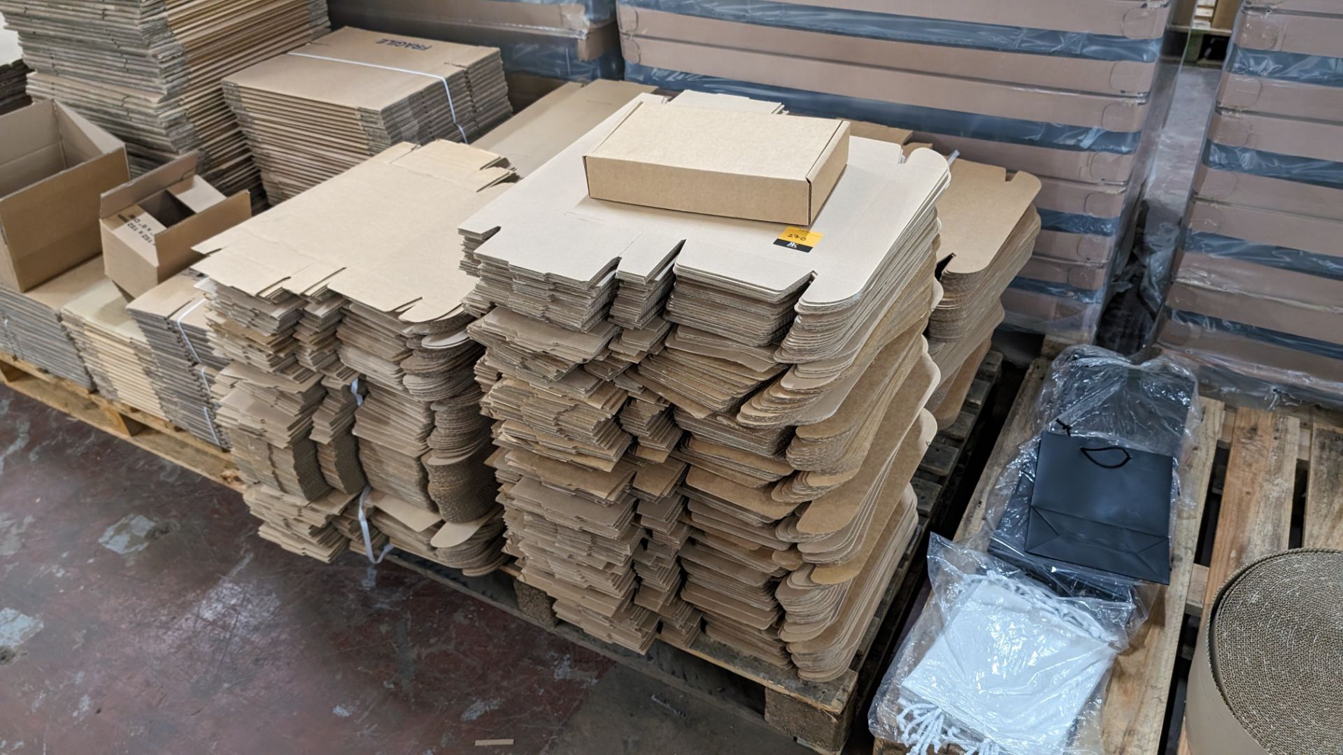 The contents of a pallet of flatpack boxes, each box incorporates a self-closing hinged lid and box