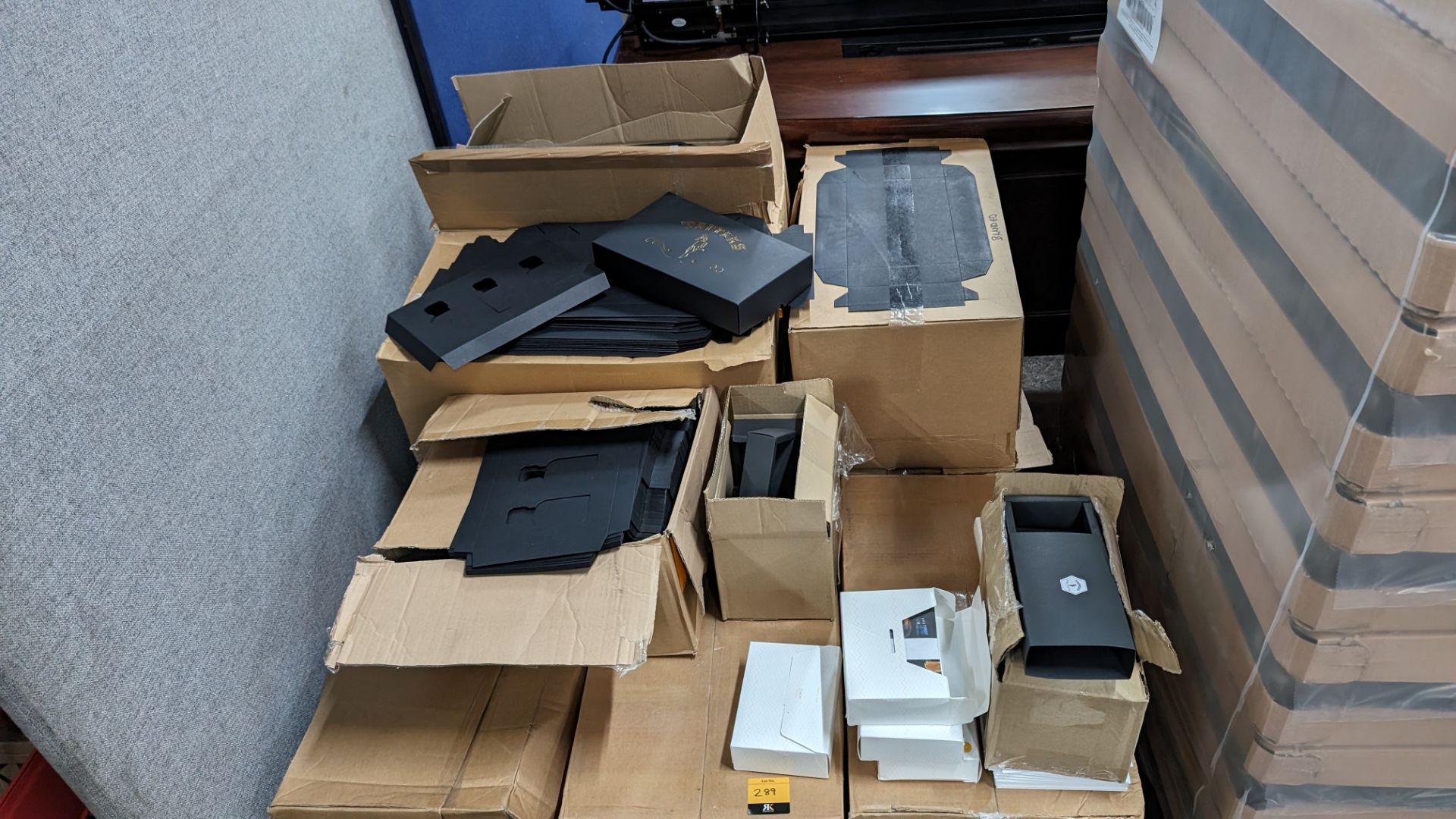 The contents of a pallet of assorted packaging materials primarily comprising flatpack black boxes b
