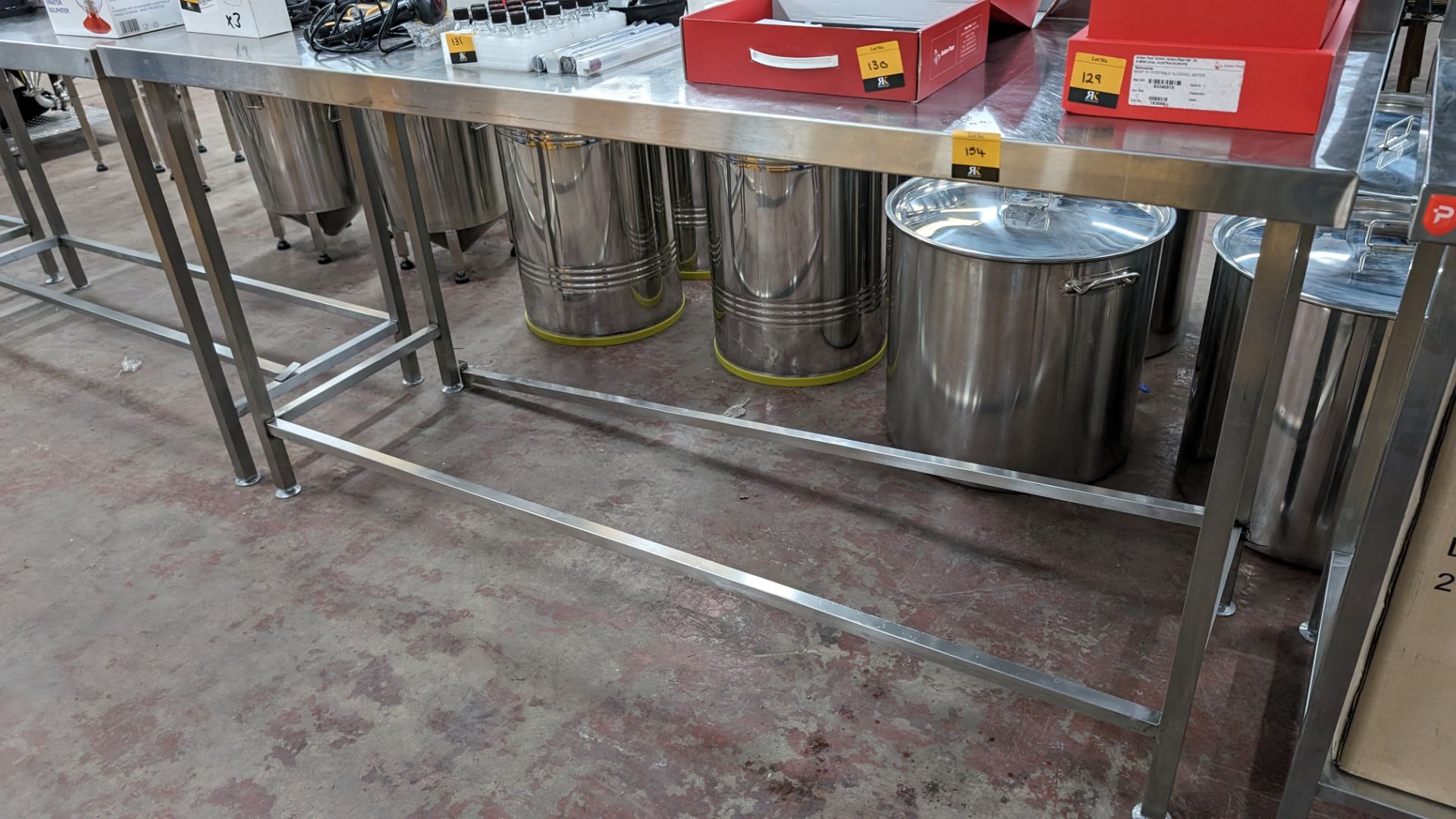 Stainless steel table with upstand at rear, max dimensions: 920mm x 600mm x 1800mm