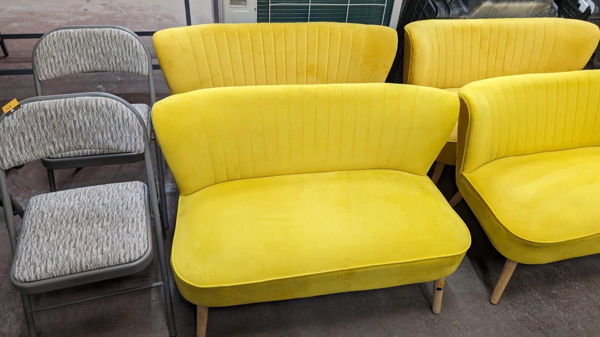 Pair of mustard yellow velour two-person small sofas, each measuring approximately 1120mm wide