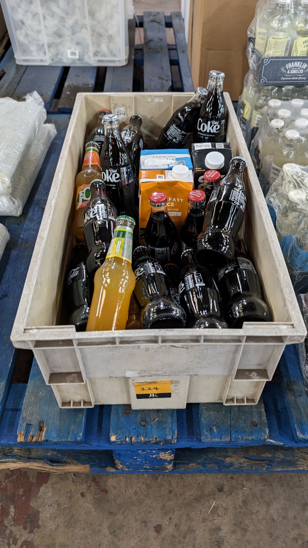 The contents of a crate of assorted soft drinks - mostly with a best before date of 2024