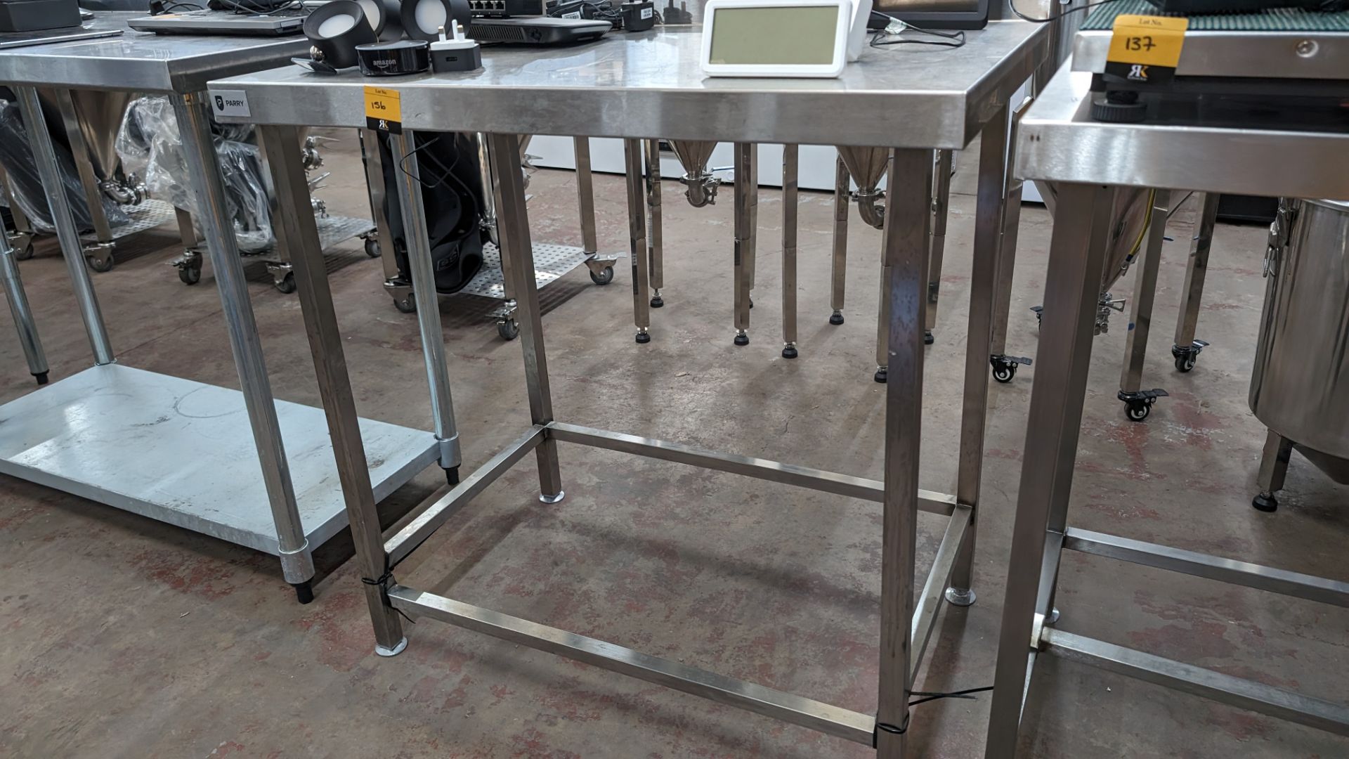 Stainless steel table with upstand at rear, max dimensions: 920mm x 600mm x 900mm