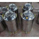 4 of 100L stainless steel milk churns, each with their own lid