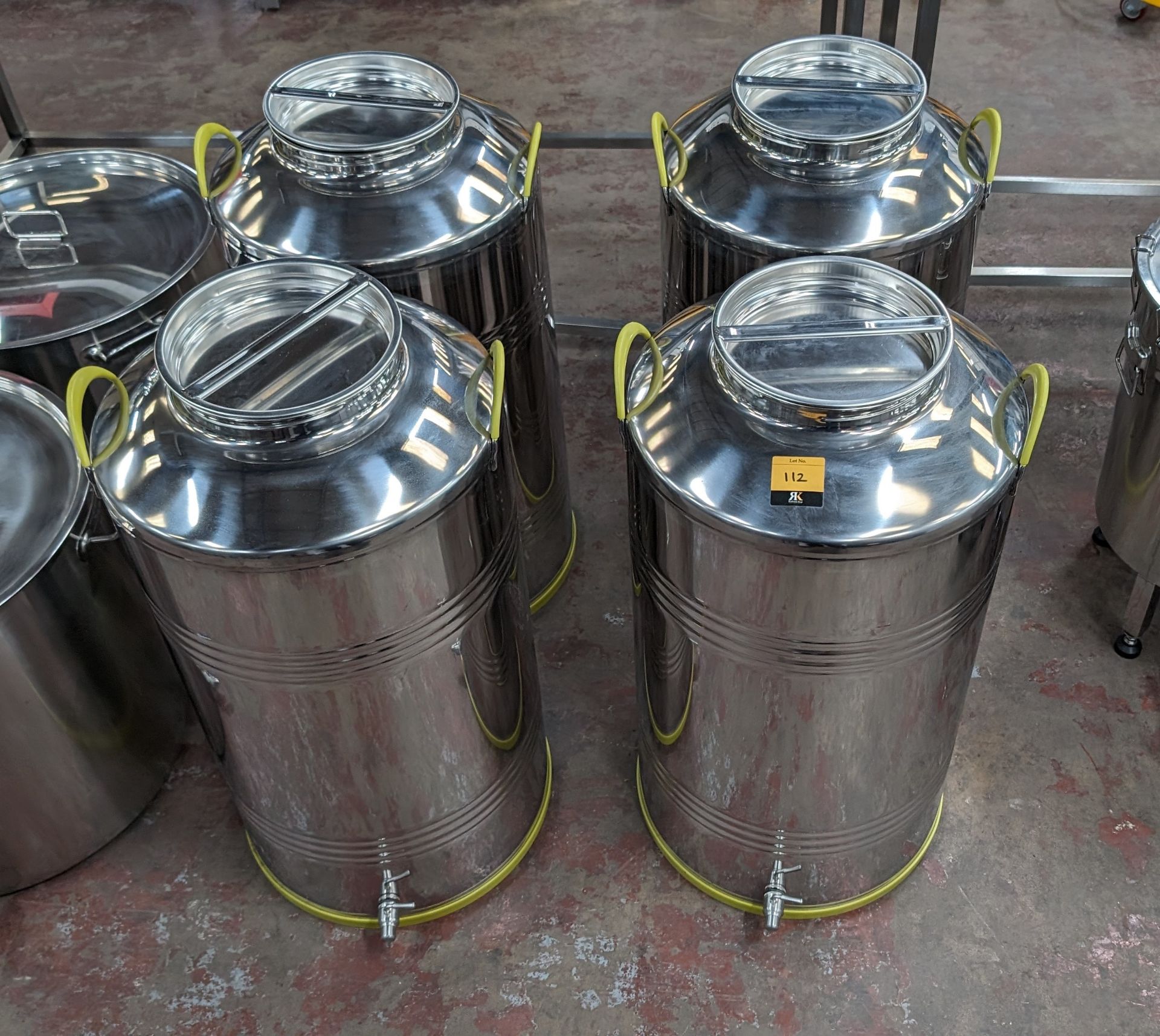 4 of 100L stainless steel milk churns, each with their own lid