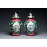 A pair of Chinese famille rose black-ground jars and covers with mountainous landscape design, Yongz