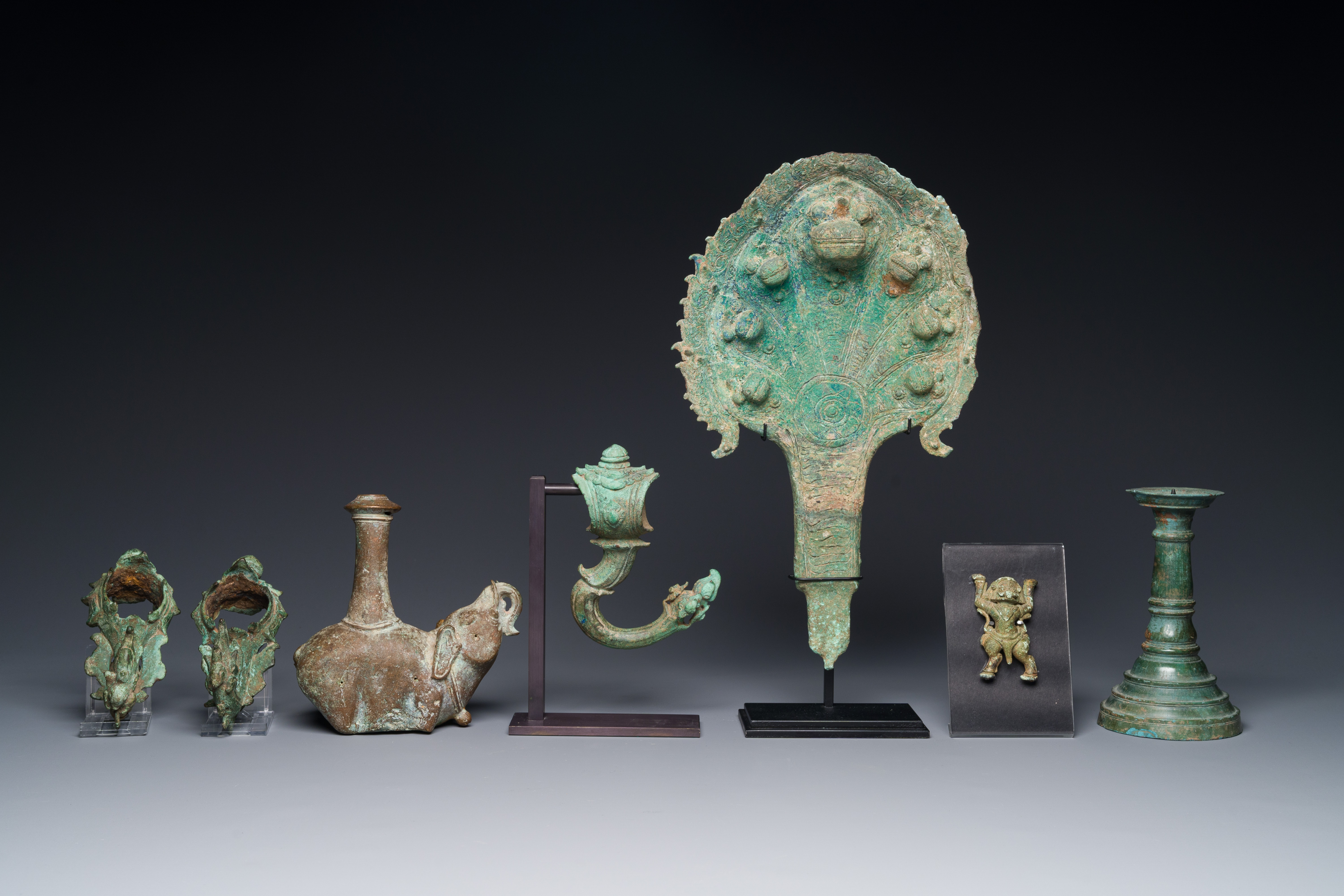 A collection of bronze sculptures, palanquin hooks and a candlestick holder, Cambodia, 13th C. and e - Image 6 of 15