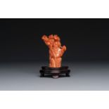 A Chinese red coral figure of Shoulao on wooden stand, 19/20th C.