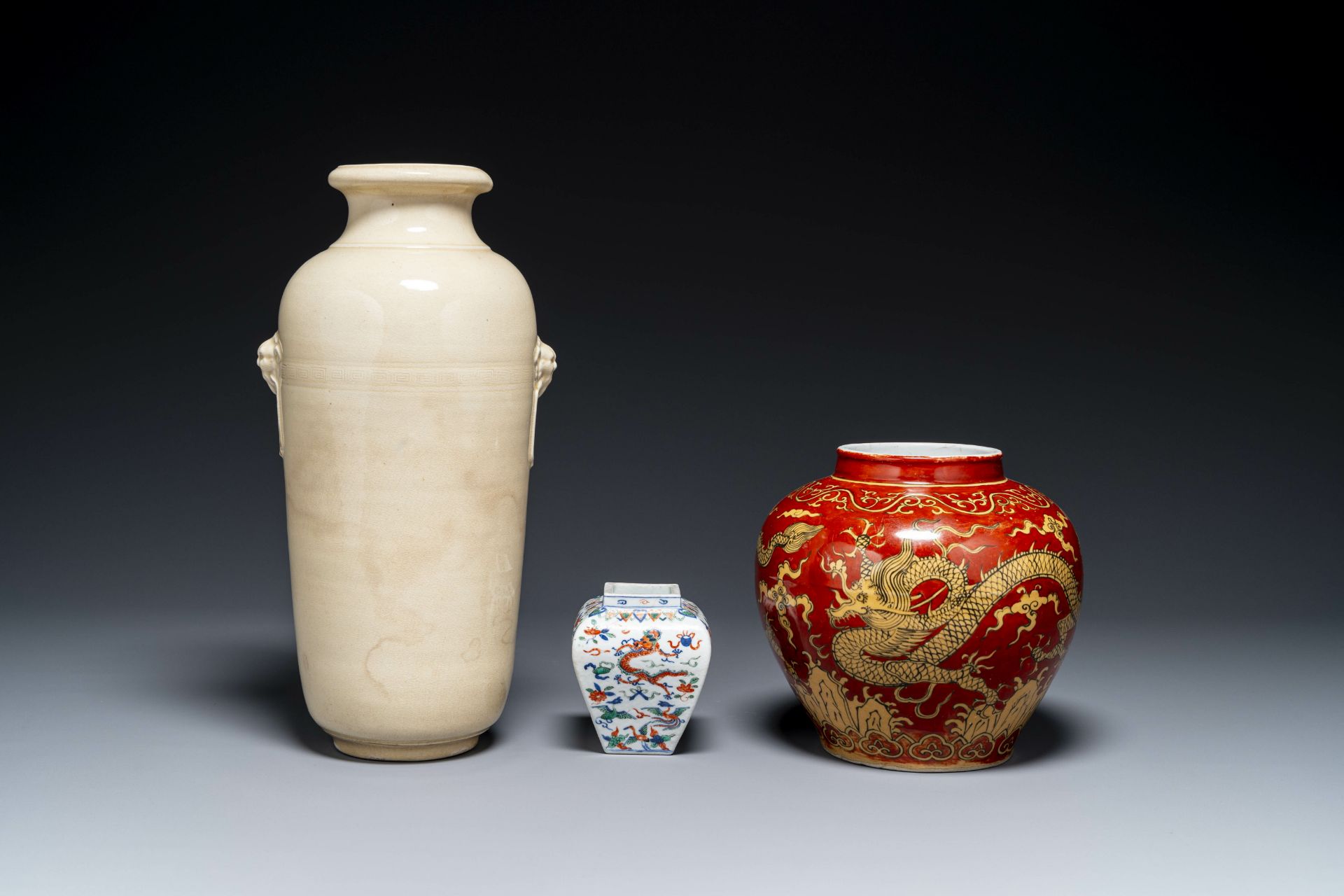 A Chinese cream-glazed vase and two 'dragon' vases, Jiajing and Wanli mark, 19/20th C.