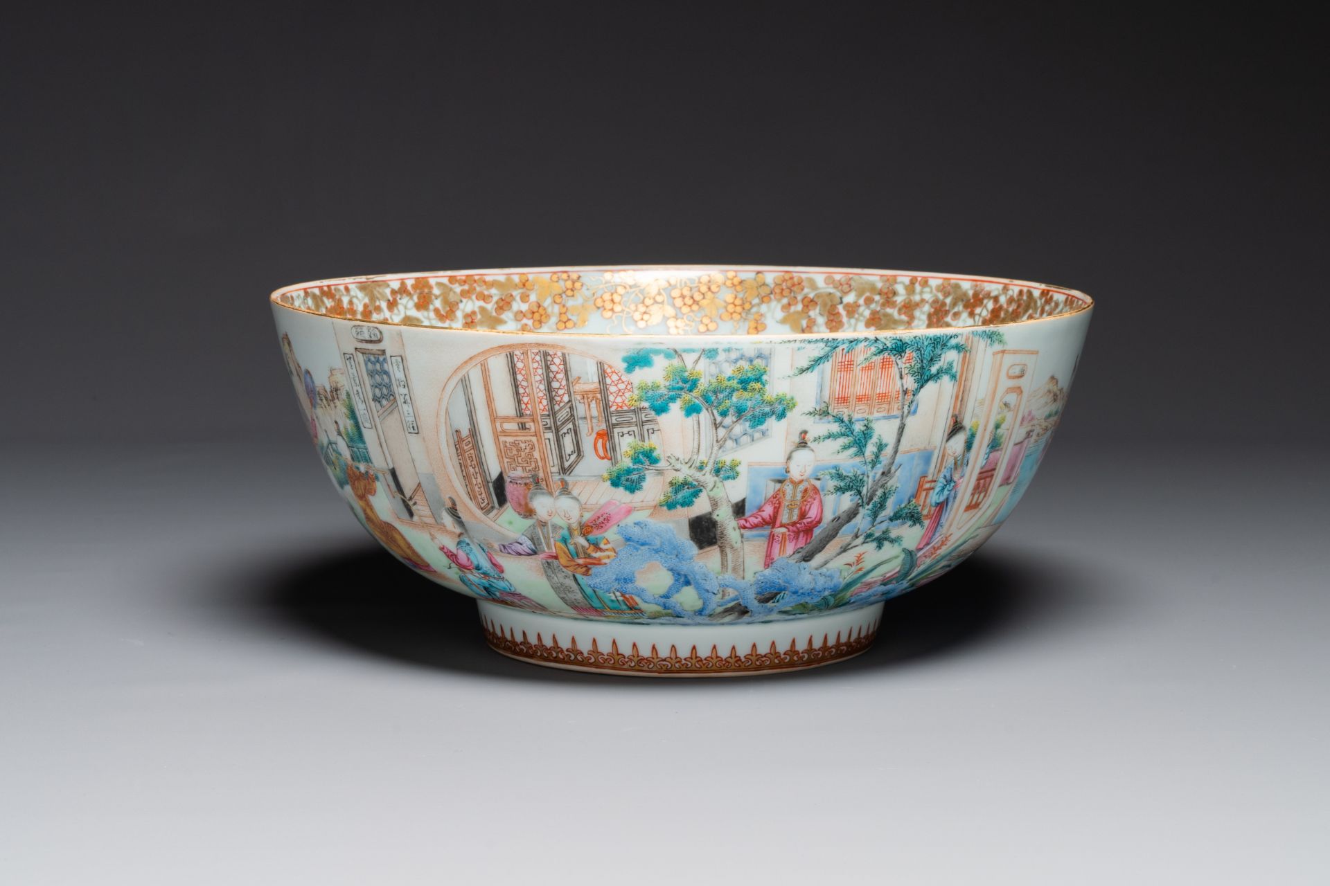 A fine large Chinese Canton famille rose bowl with boys and ladies in an elaborate garden scene, Qia