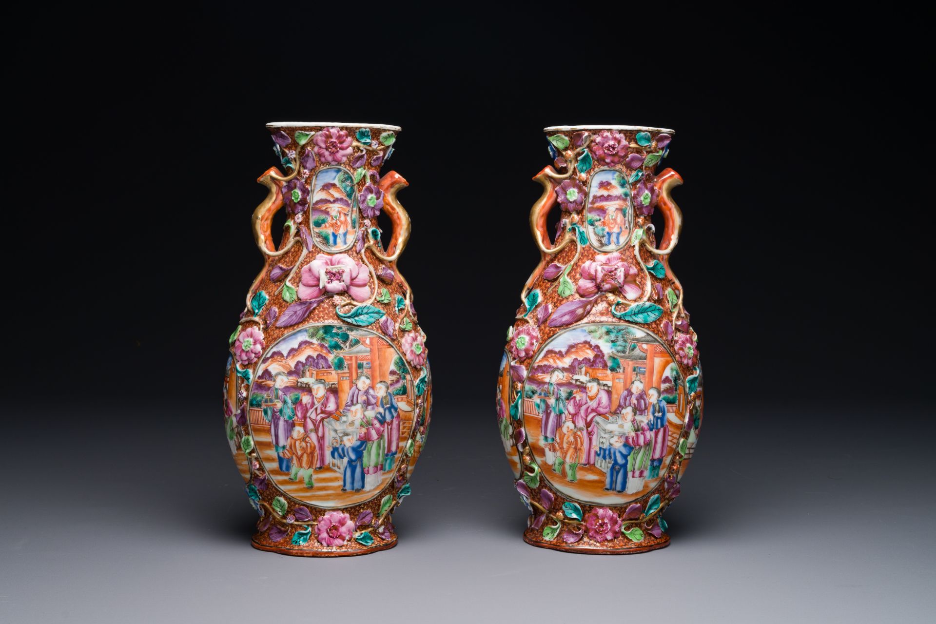 A pair of Chinese Canton famille rose 'mandarin subject' vases with floral relief design, Qianlong - Image 3 of 6