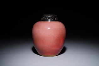 A Chinese monochrome copper-red-glazed ginger jar with a reticulated wooden cover, 18/19th C.