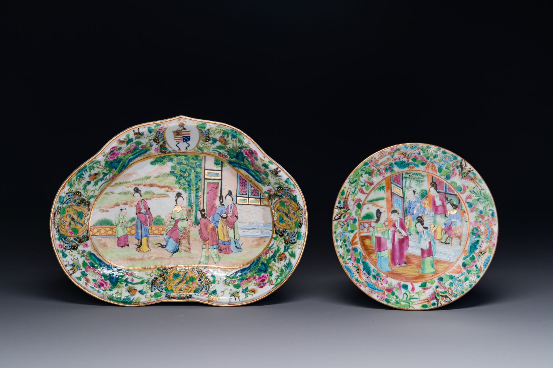 A Chinese Canton famille rose lobed armorial dish and a plate, 19th C.