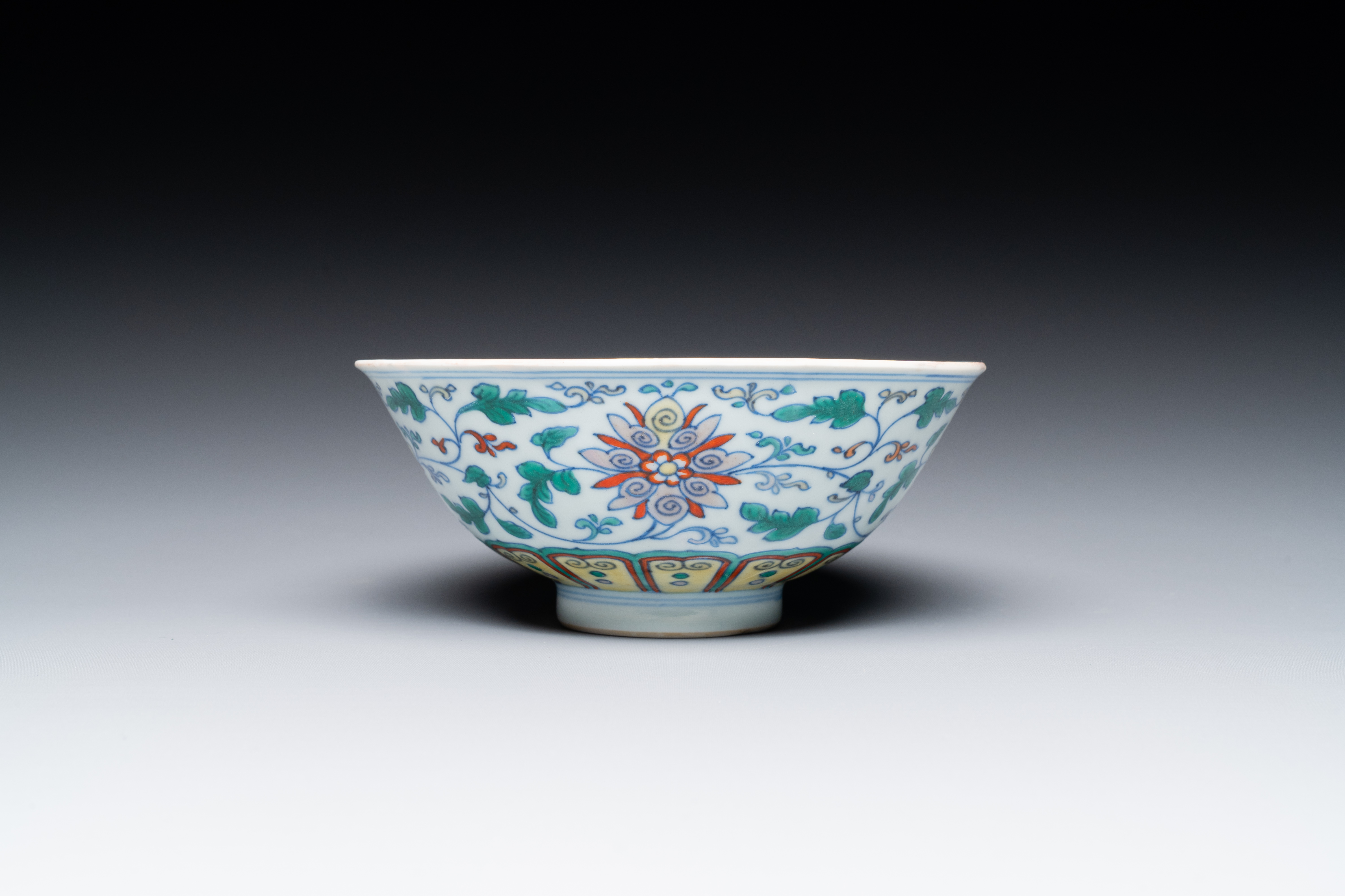 A Chinese doucai 'lotus scroll' bowl, Qianlong mark and of the period - Image 3 of 7