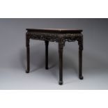 A rectangular Chinese carved wooden console table with a pink marble top, 19th C.