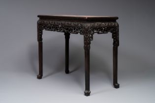 A rectangular Chinese carved wooden console table with a pink marble top, 19th C.