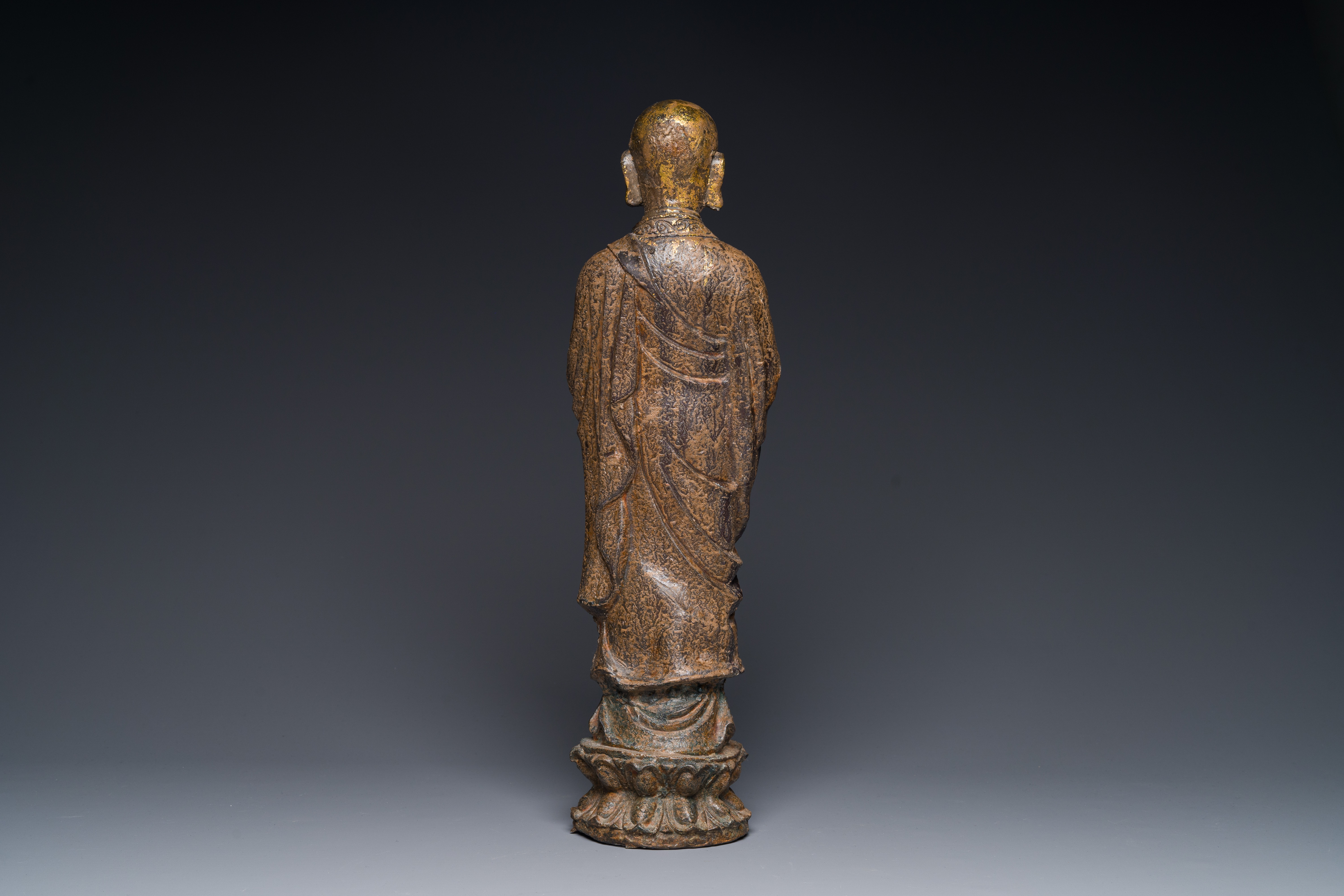 A Chinese gilt cast iron figure of a standing monk, Ming - Image 2 of 3