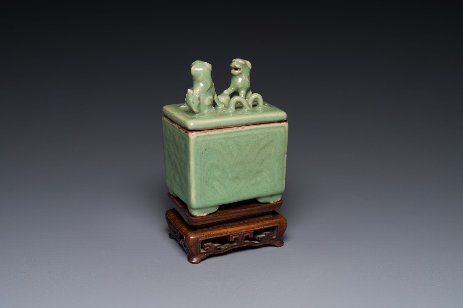 A Chinese Longquan celadon rectangular censer and cover on wooden stand, Ming