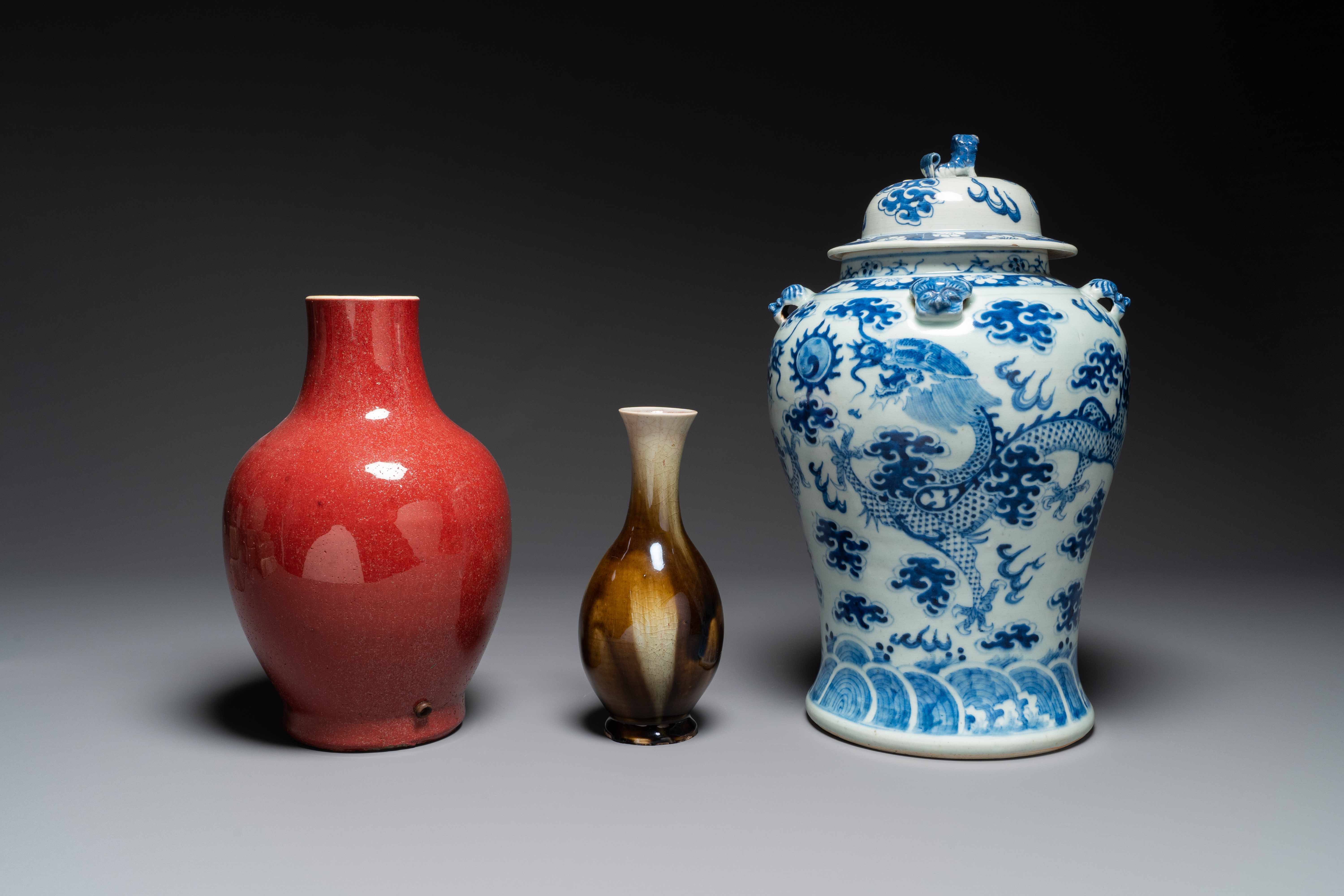 Two Chinese monochrome-glazed vases and a blue and white covered vase, 19th C.