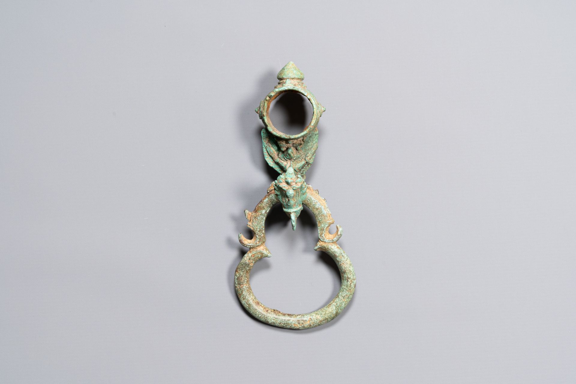 A bronze Khmer Bayon-style hanging hook from a palanquin, Angkor period, 12/13th C.