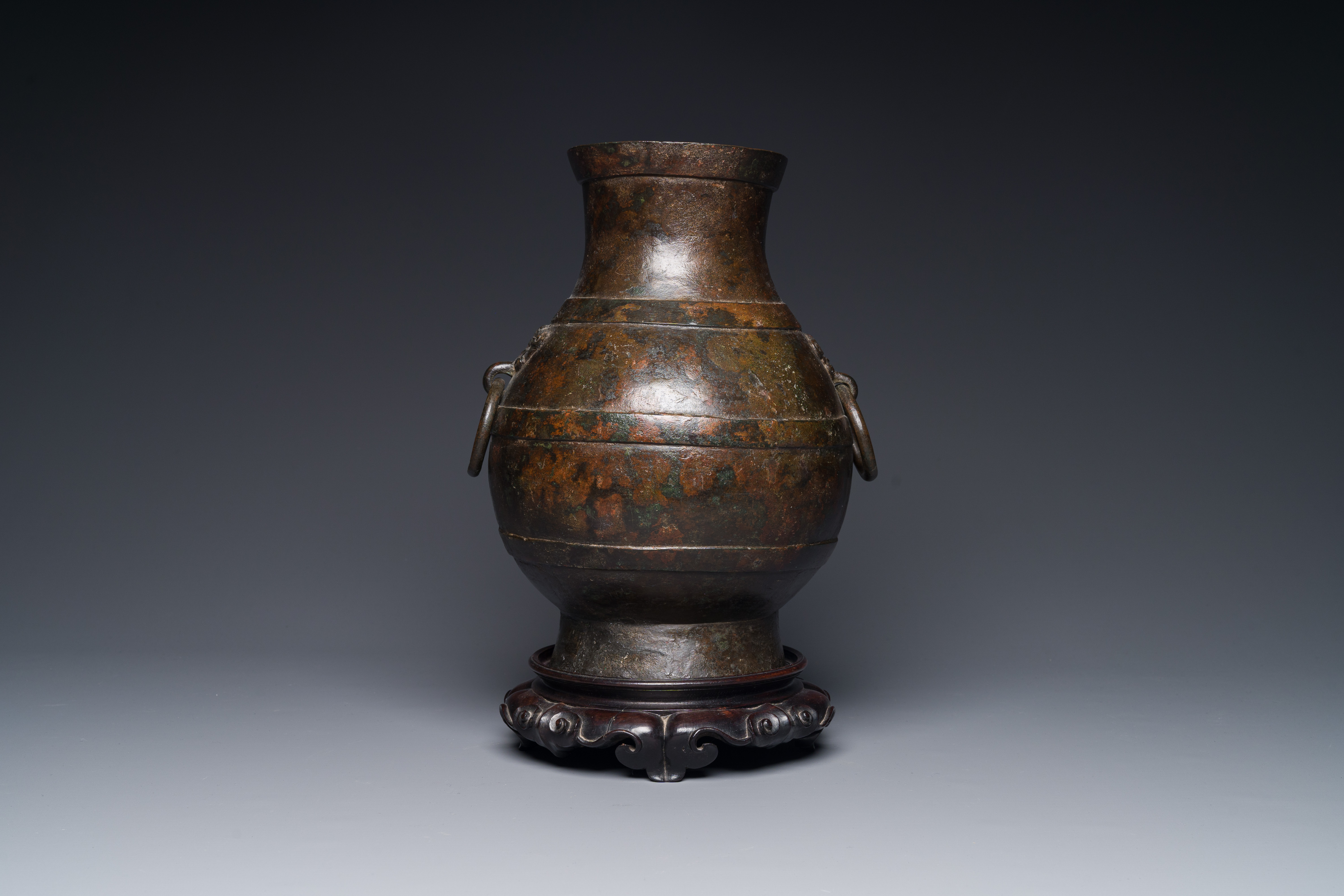 A Chinese bronze 'hu' vase with Han-style taotie handles on wooden base, Ming - Image 2 of 12