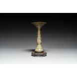 A Chinese bronze Shang-style 'gu' vase on wooden stand, 19/20th C.