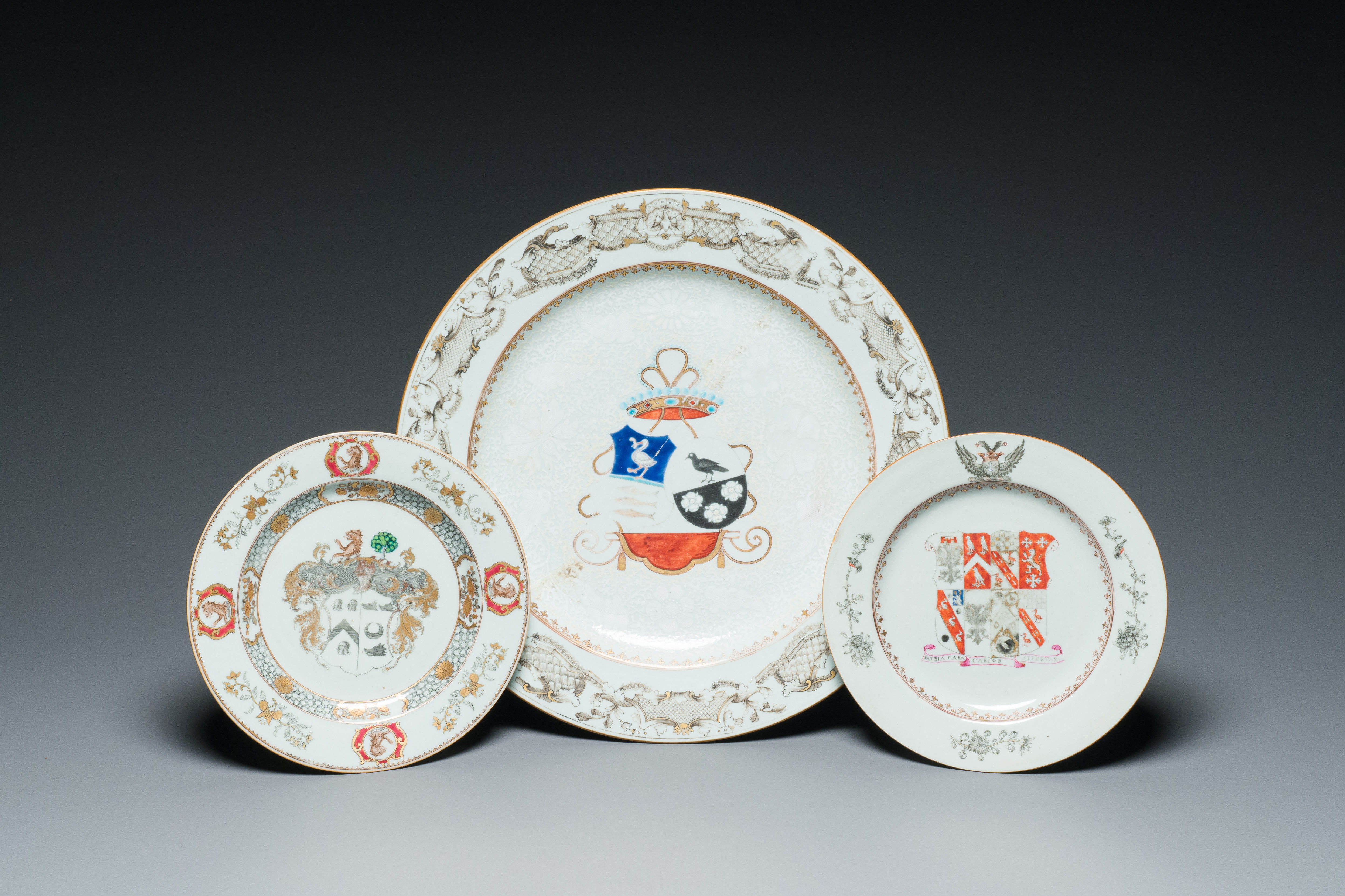 A Chinese grisaille armorial dish and two plates for the Dutch, English and Scottish markets, Qianlo