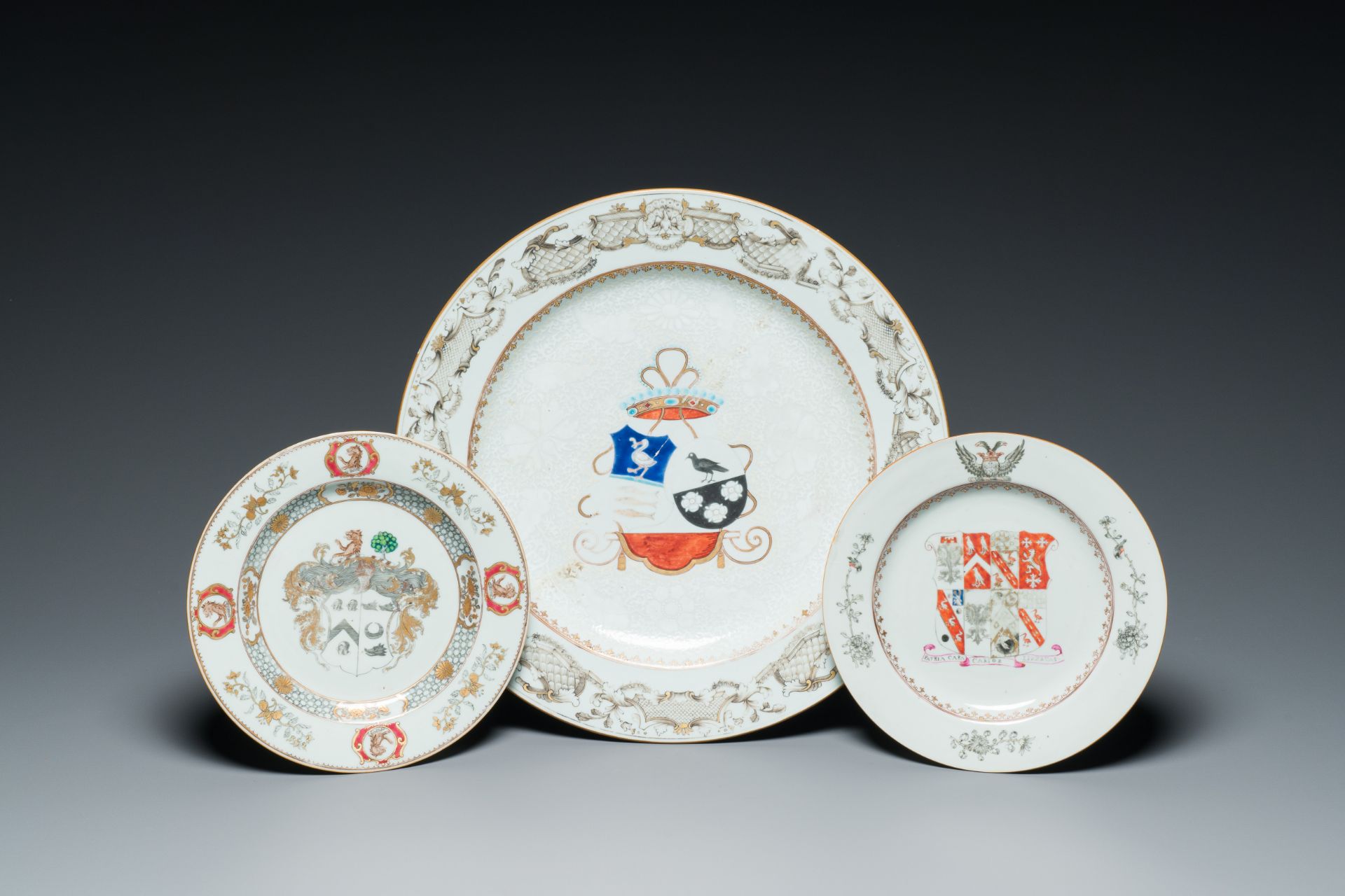A Chinese grisaille armorial dish and two plates for the Dutch, English and Scottish markets, Qianlo