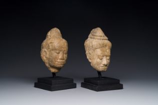 A stone head of Buddha and a sandstone khmer head of a deity, Bayon style, Cambodia, 12/13th C.