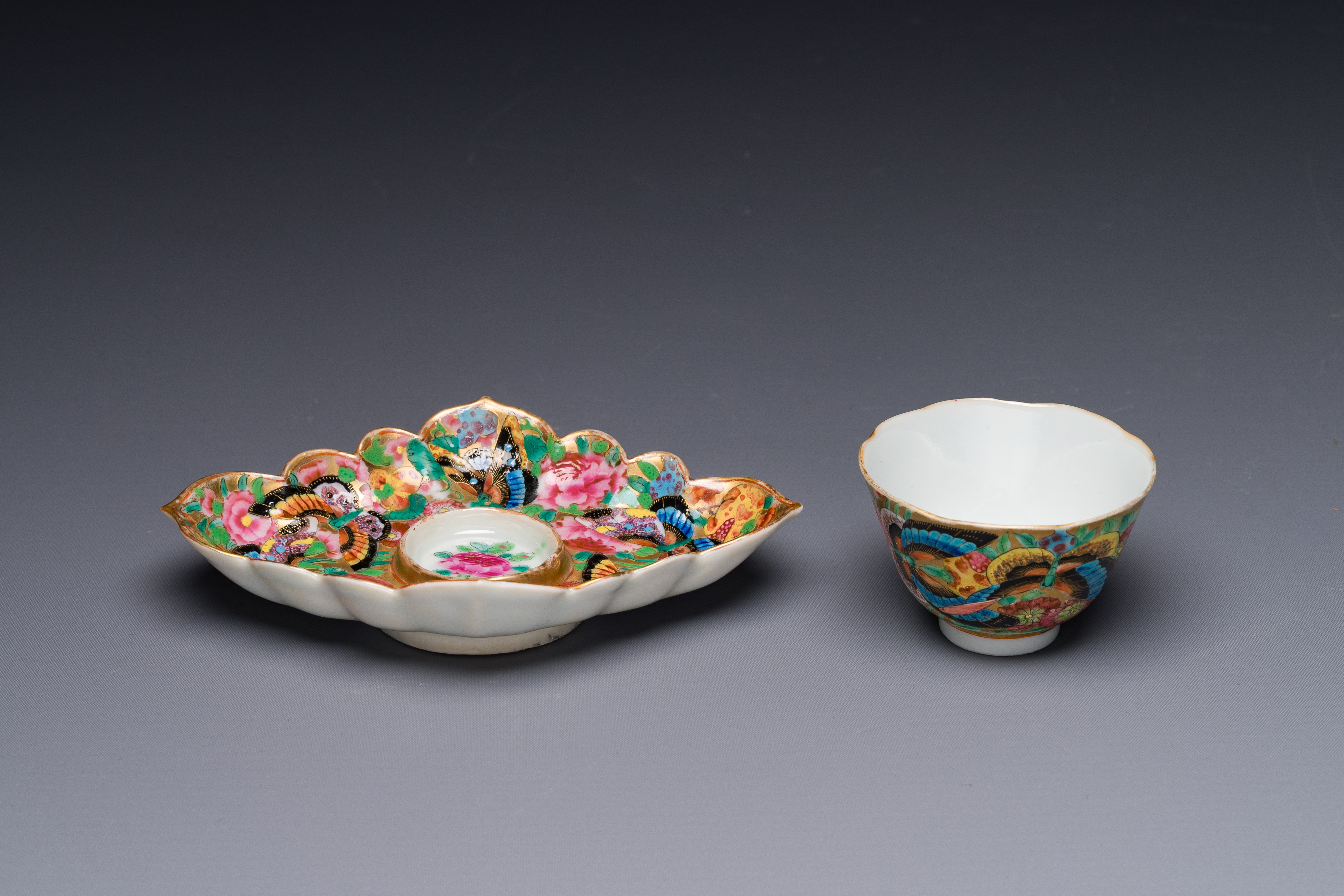 A Chinese Canton famille rose gilt-decorated cup and stand with flowers and butterflies, 19th C. - Image 3 of 5