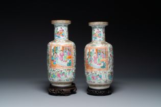 A pair of Chinese Canton famille rose vases with wooden stands, 19th C.