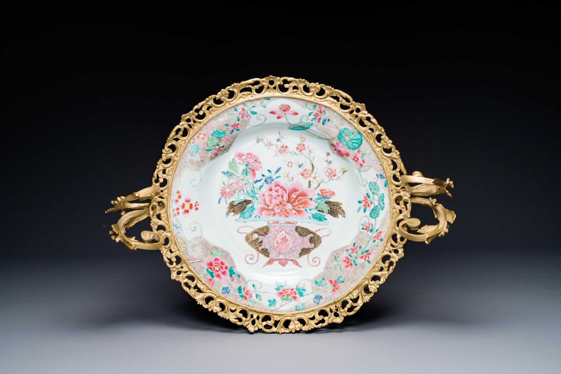 A Chinese famille rose 'flower basket' dish with gilt bronze mount, Yongzheng