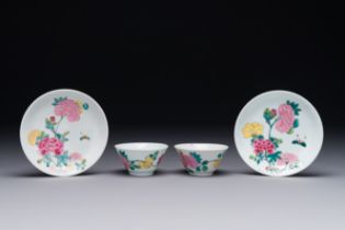 A pair of Chinese famille rose 'peony' cups and saucers, Yongzheng