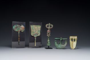 A collection of three bronze axes, a mirror and an anthropomorphic idol with two dragon heads, Luris
