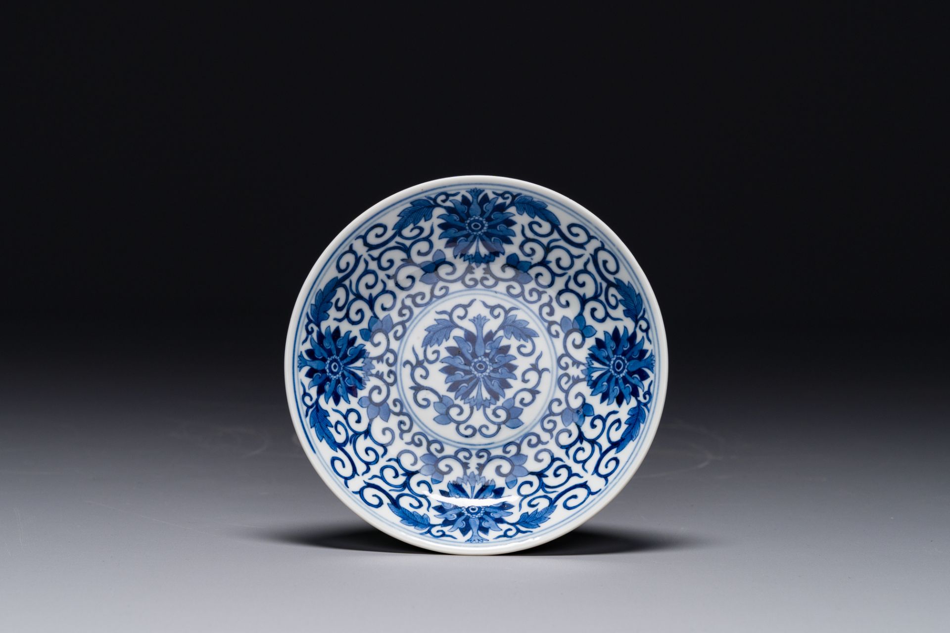 A Chinese blue and white 'lotus scroll' plate, Guangxu mark and of the period