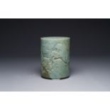 A Chinese spinach jade brush pot with relief design, 18th C.