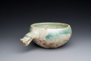 A Chinese monochrome green-glazed pottery scoop, Han