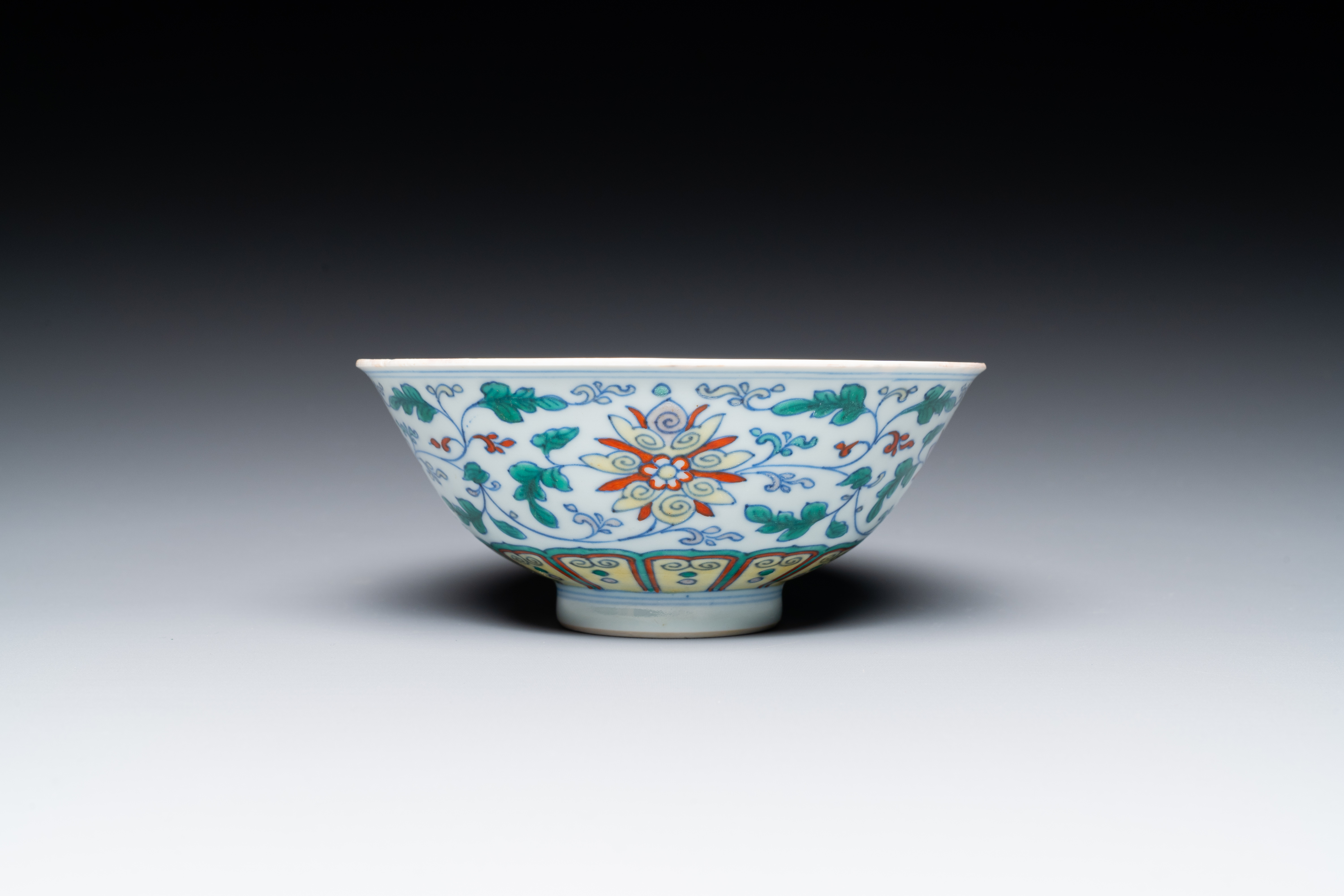 A Chinese doucai 'lotus scroll' bowl, Qianlong mark and of the period - Image 4 of 7