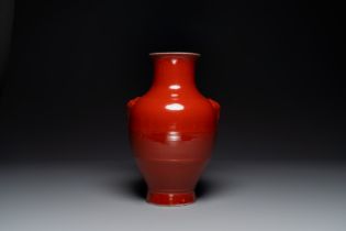 A Chinese monochrome red-glazed 'hu' vase, Qianlong mark, 19th C.