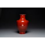 A Chinese monochrome red-glazed 'hu' vase, Qianlong mark, 19th C.